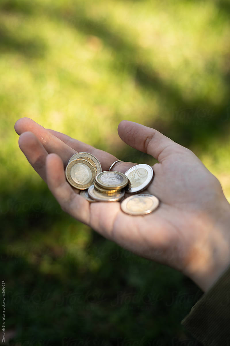 Woman hand with euro coins