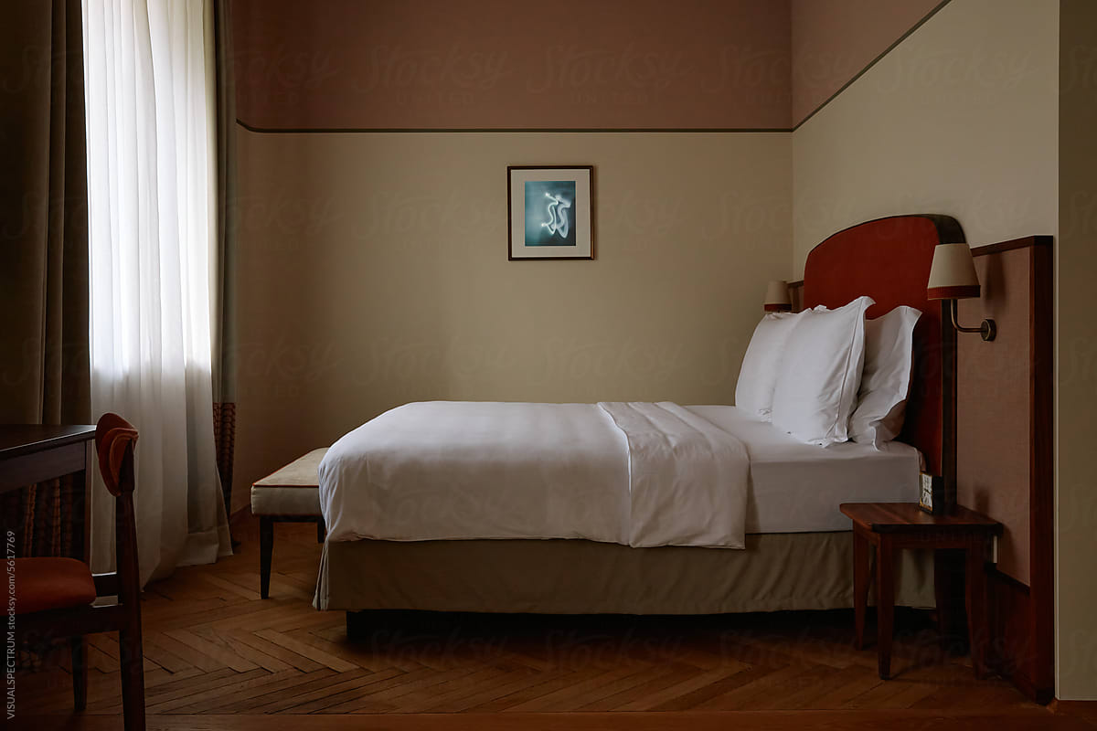 Moody Bedroom With Herringbone Parquet and Earthy Tones