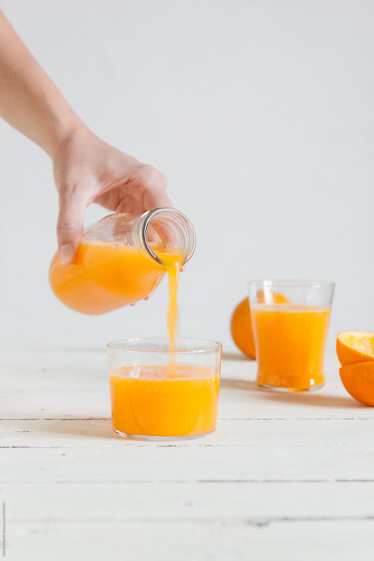 Pouring fresh orange juice in a glass