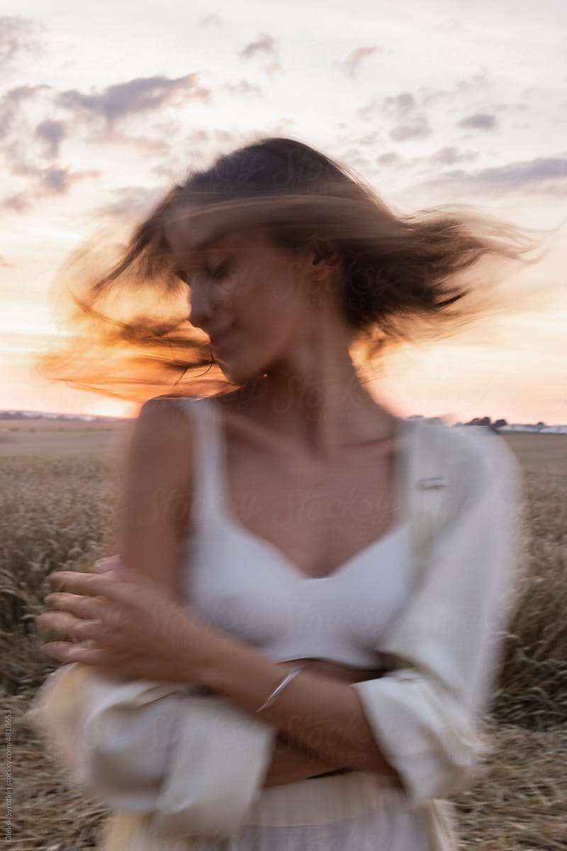 Blurred portrait of stylish girl in field