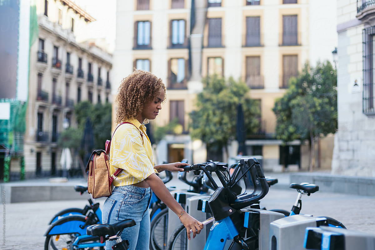 Woman Renting an electric Bike At City