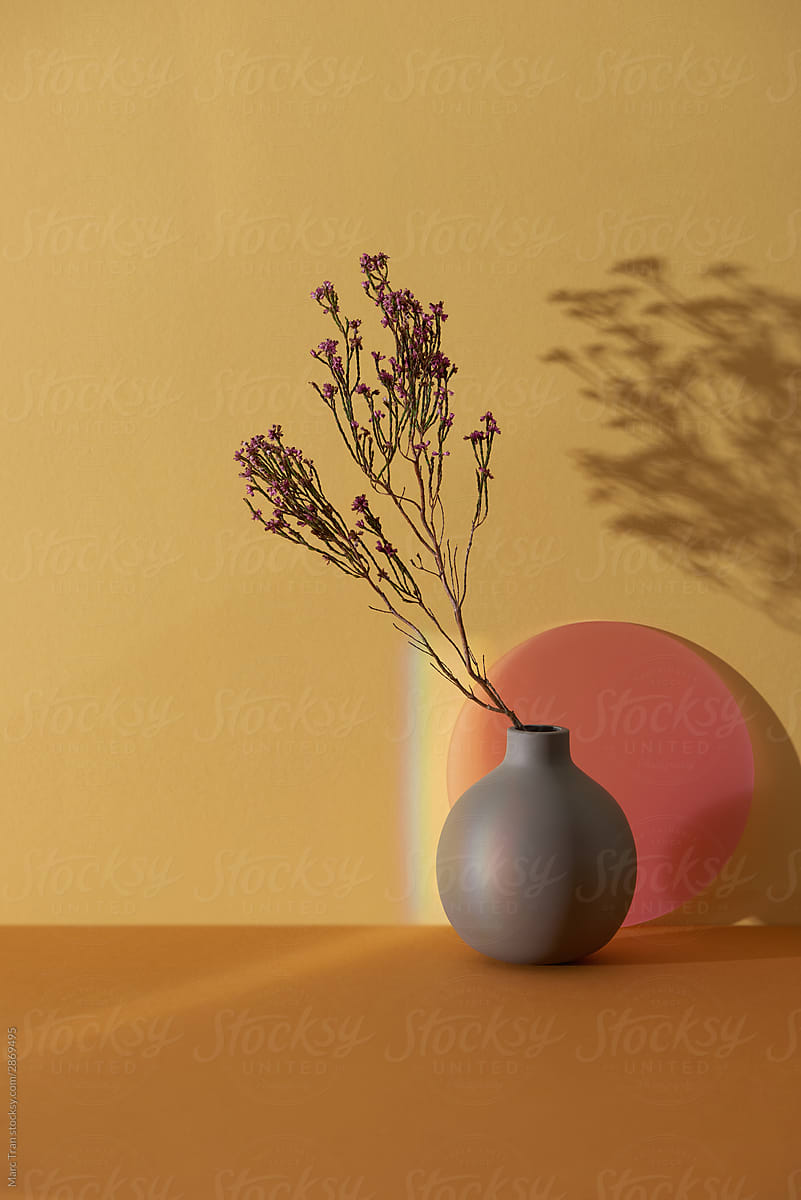 Pink flower in vase gray on color background