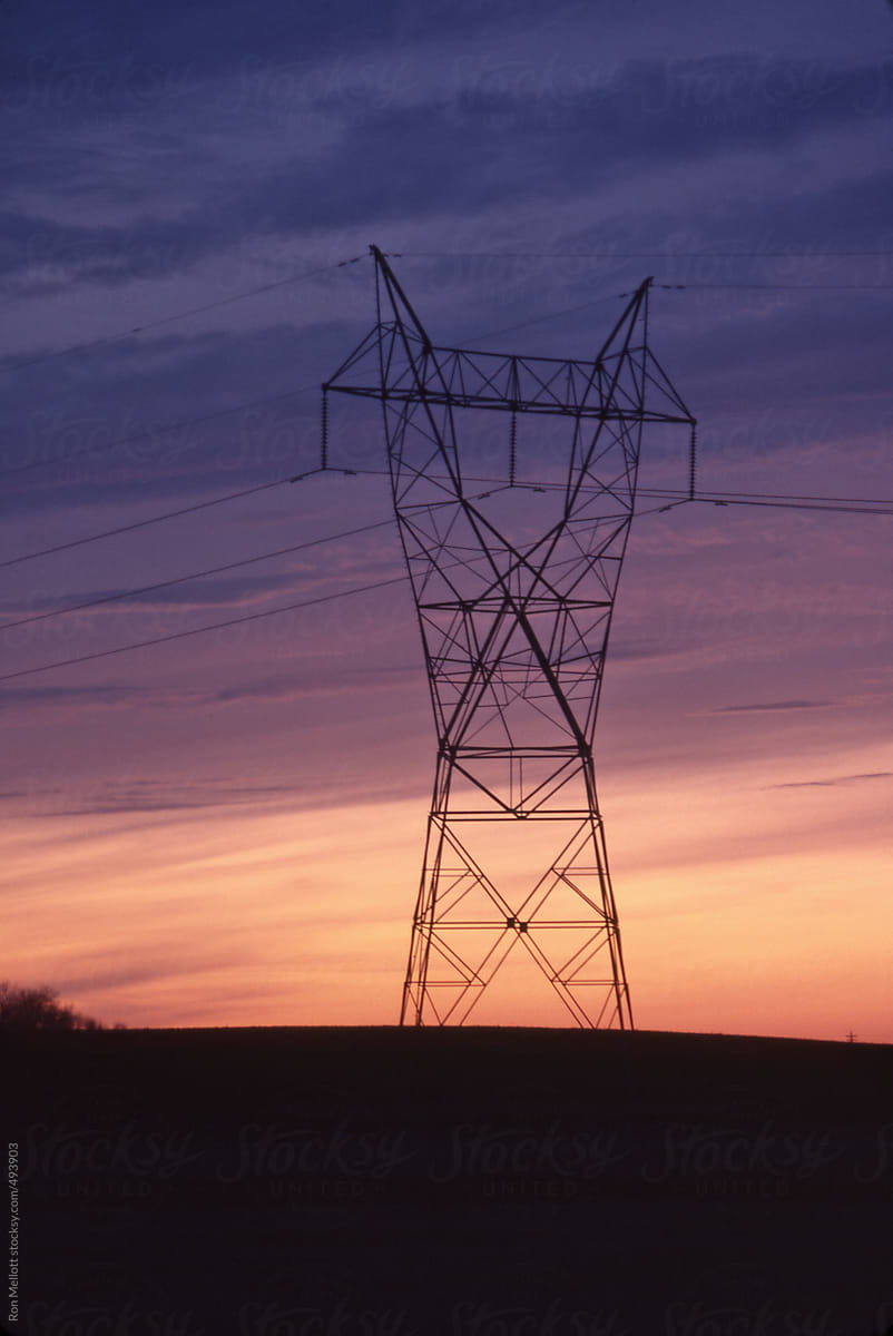 power line electrical tower at sunset on prairies of Saskatchewan, Canada