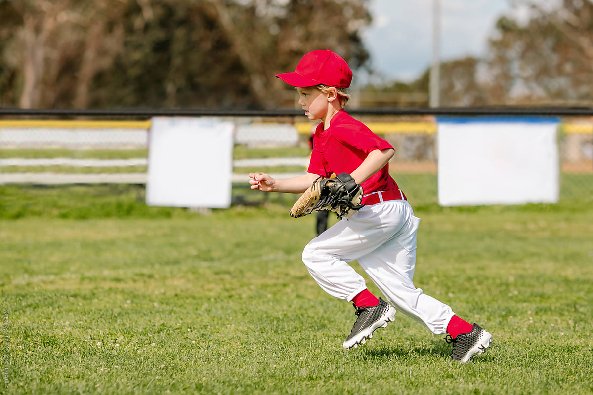 Boy in the outfield during little league game