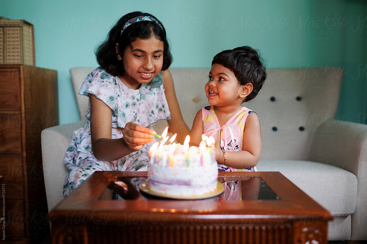 Baby girl celebrates her birthday with elder sister