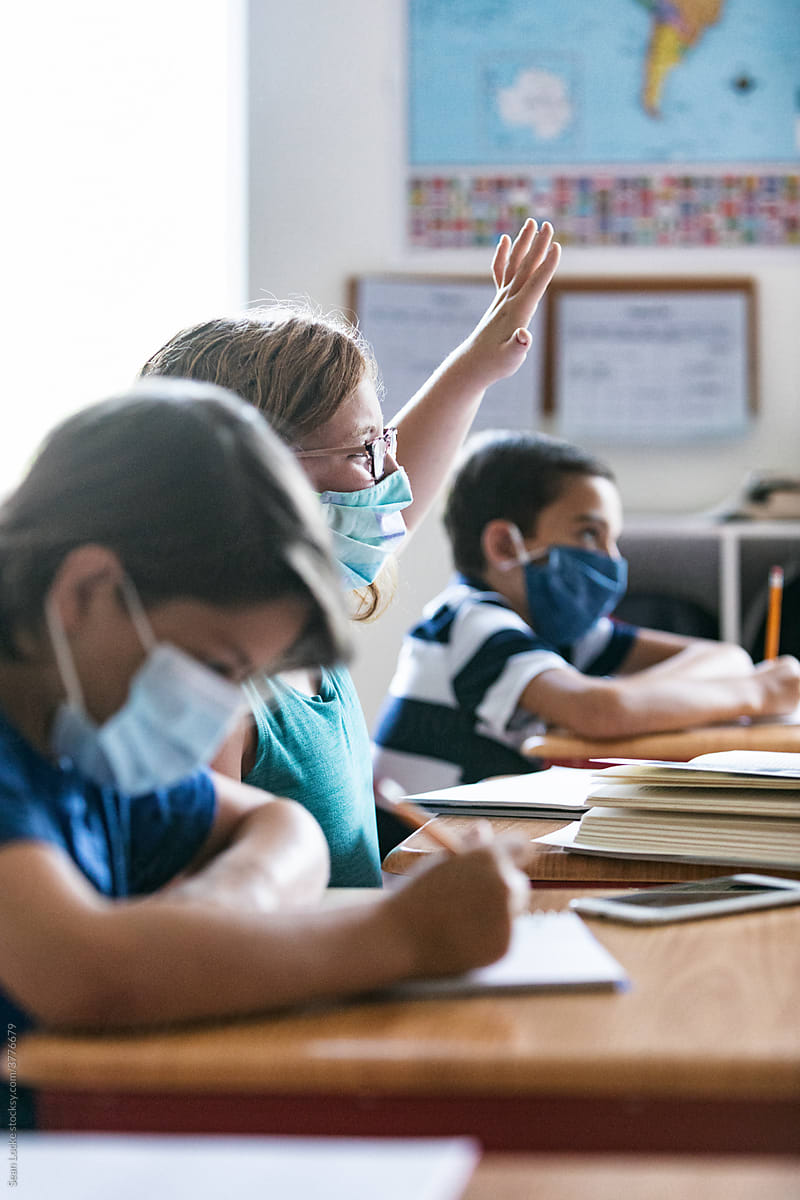 School: Girl Student With Face Mask Raises Hand