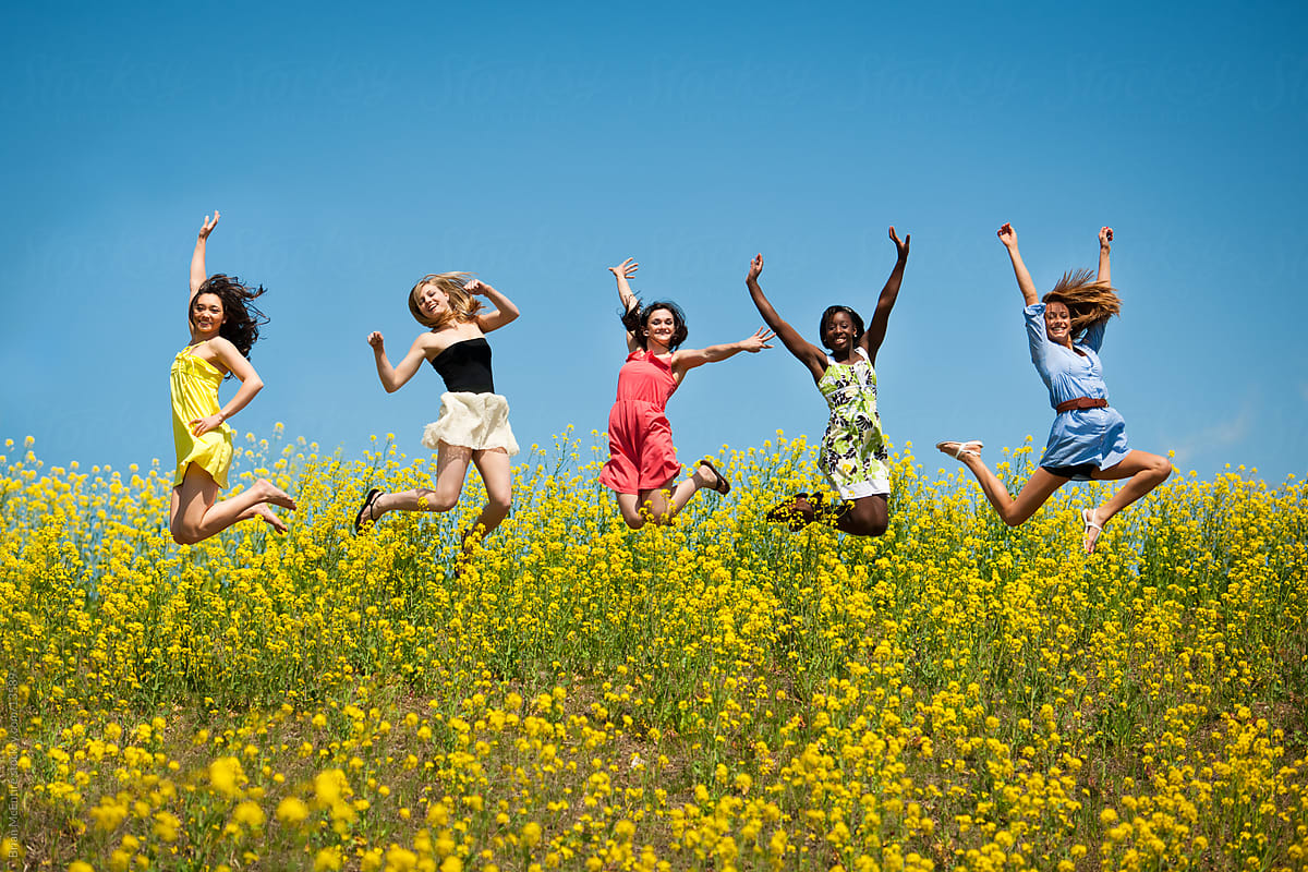 High School Senior Girls Jump in Flower Field