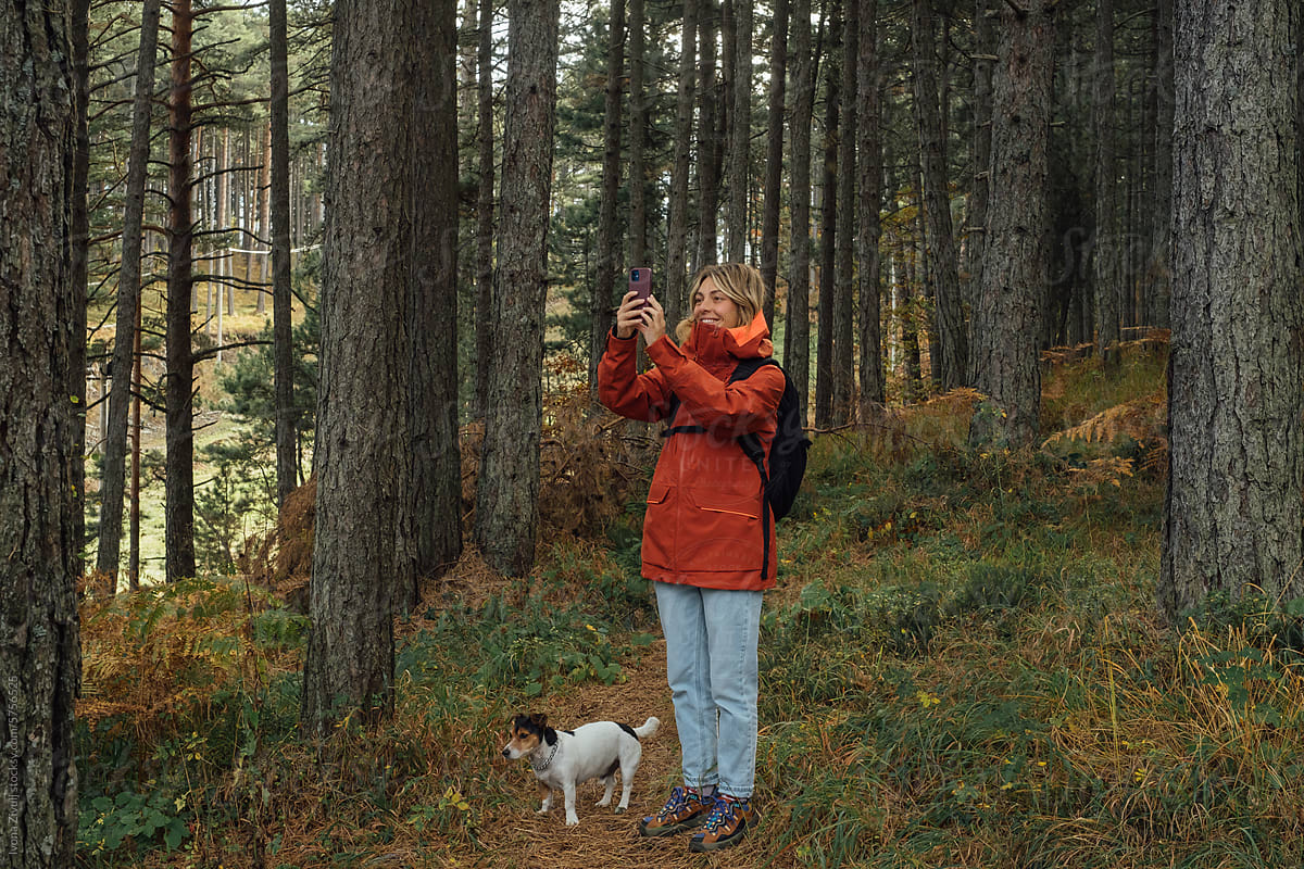 Woman Hiker Taking Picture With Mobile Phone in Forest