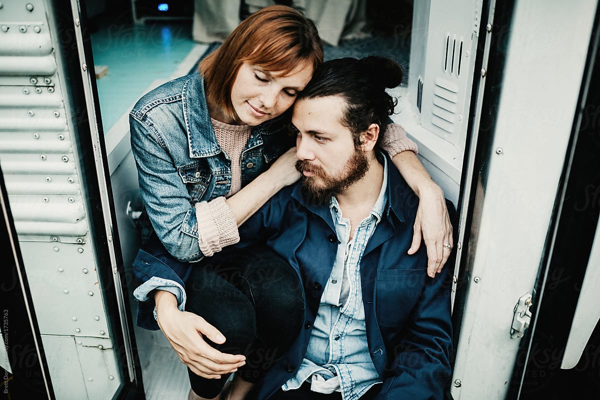 Cute Hipster Couple Cuddling In Converted School Bus Tiny Home By Stocksy Contributor Brett