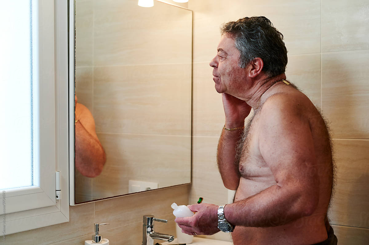 Mature man aftershave in his bathroom