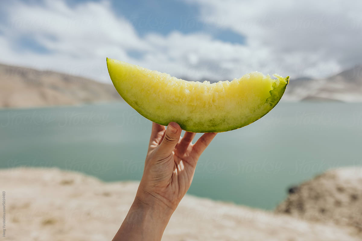 Melon Slice Against Lake Scenery