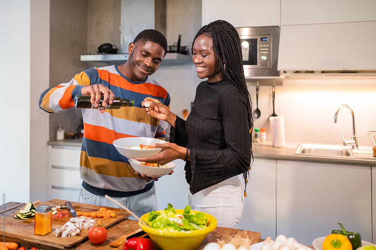 Lovely Black Couple Cooking Vegetables At Home.