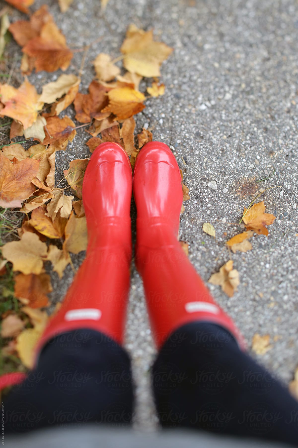 Walking In Red Rain Boots On An Autumn Day