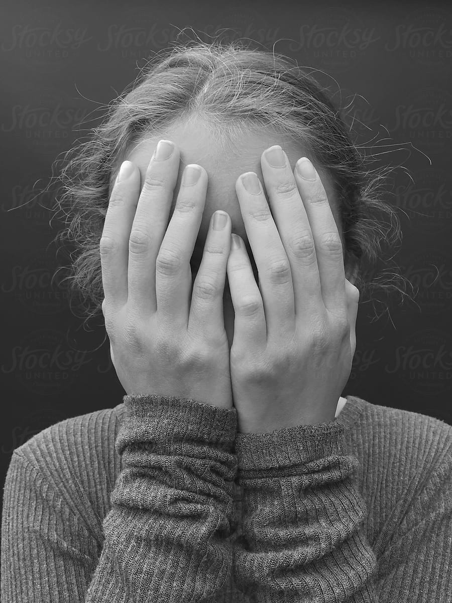 Portrait Of Teenage Girl With Hands  Covering Face  Close 