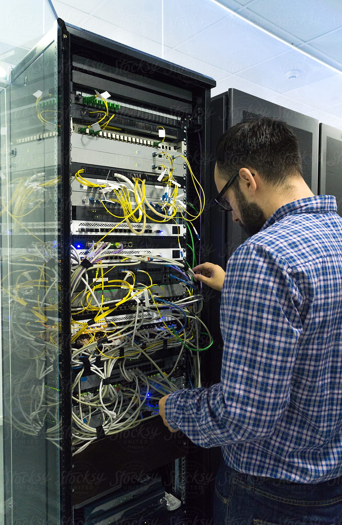 Technician performing maintenance tasks in a server of communica