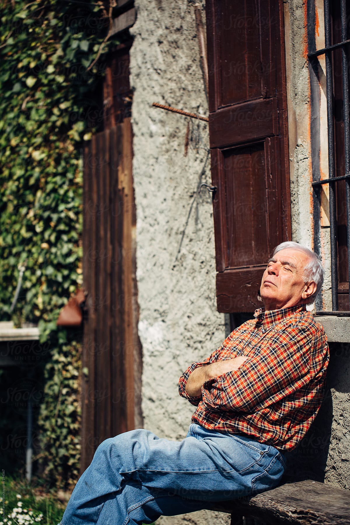 An elderly man sitting in the sun