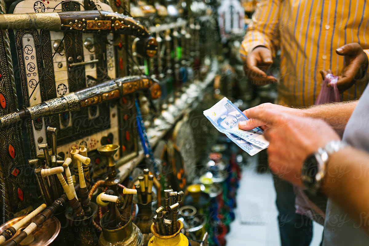 Man handing over money in a North African market.
