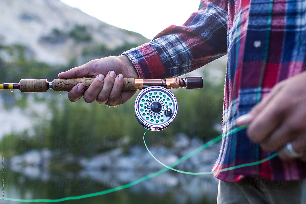 Man holds his fly fishing rod