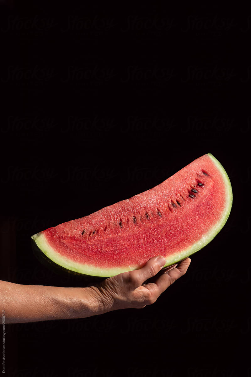 Person holding bite watermelon