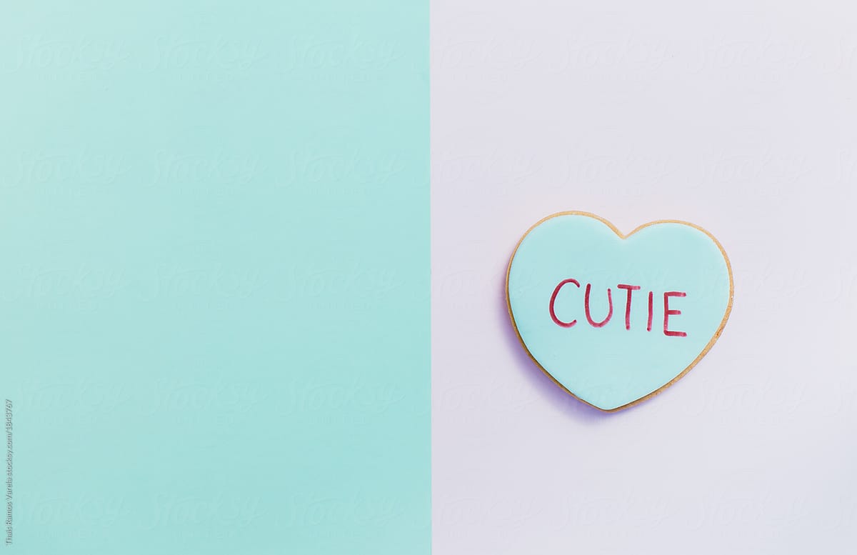pale valentine candy cookies with messages over pastel background