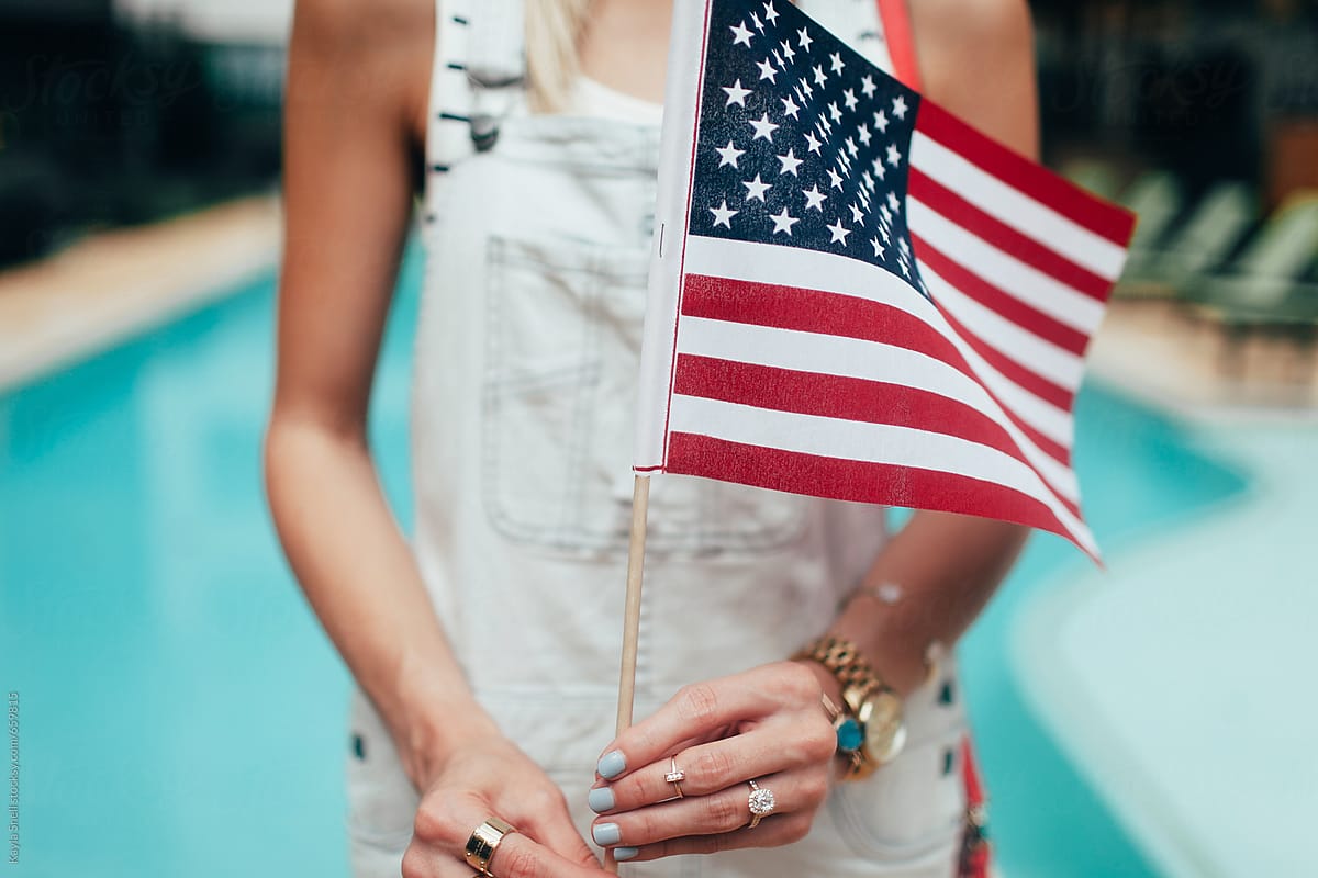 A young  woman holding an american flag