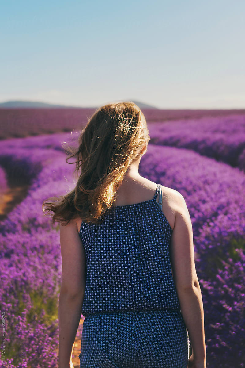 girl walking amongst rows of lavender