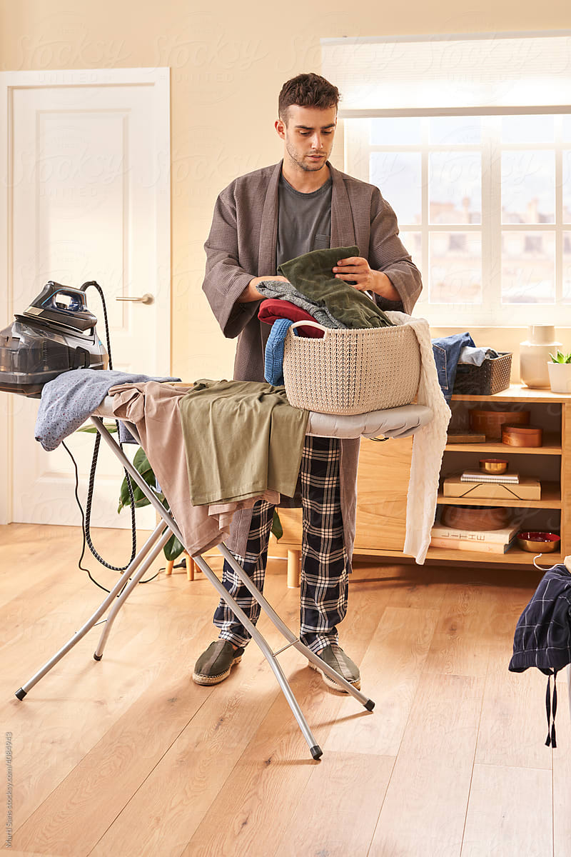 Man sorting clothes in basket