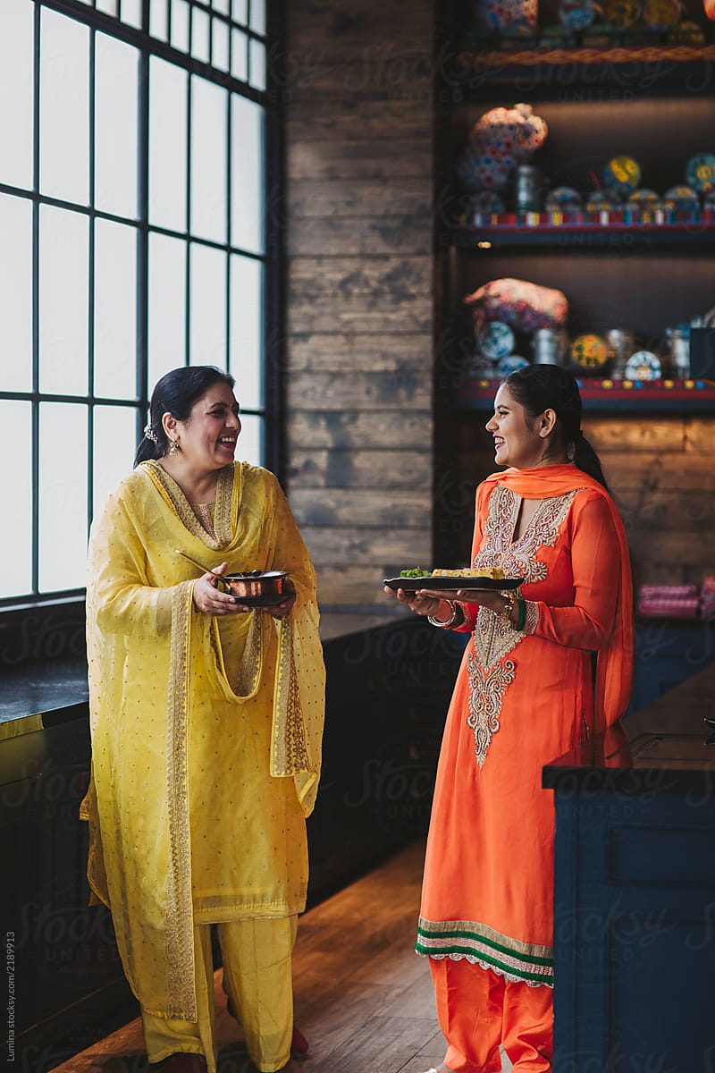Indian Women Serving Traditional Dishes