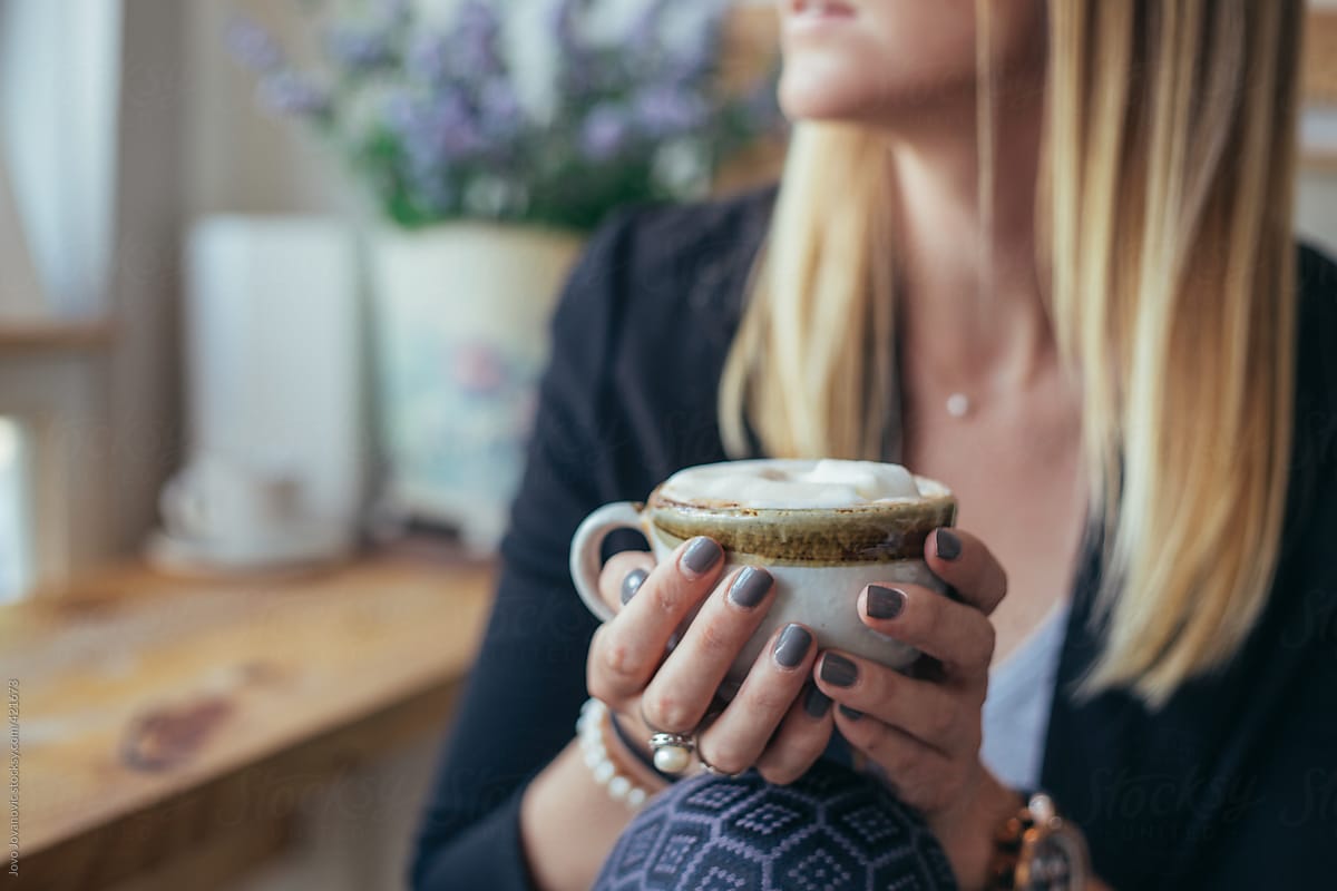 Blonde woman enjoying her cup of delicious coffee