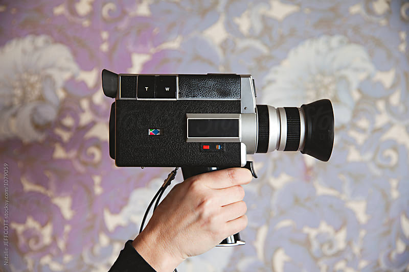 Old super 8 anologue video camera against purple wallpaper
