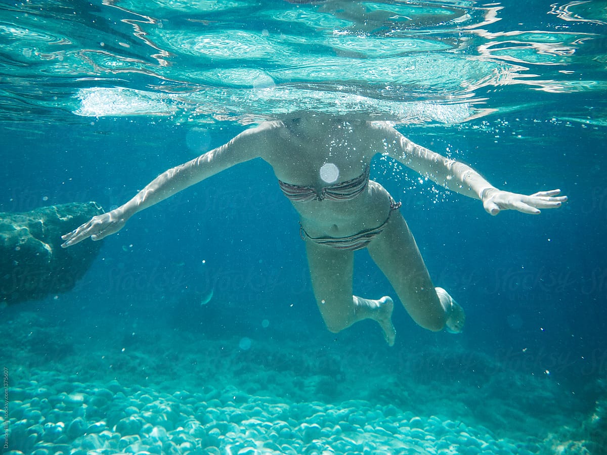 Young Woman Underwater In A Clear Sea By Stocksy Contributor Davide 9555