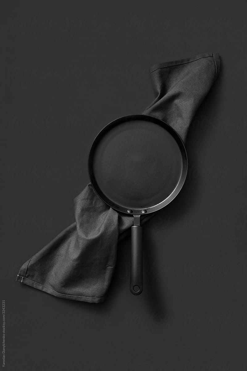 Cooking black pan served textile towel.