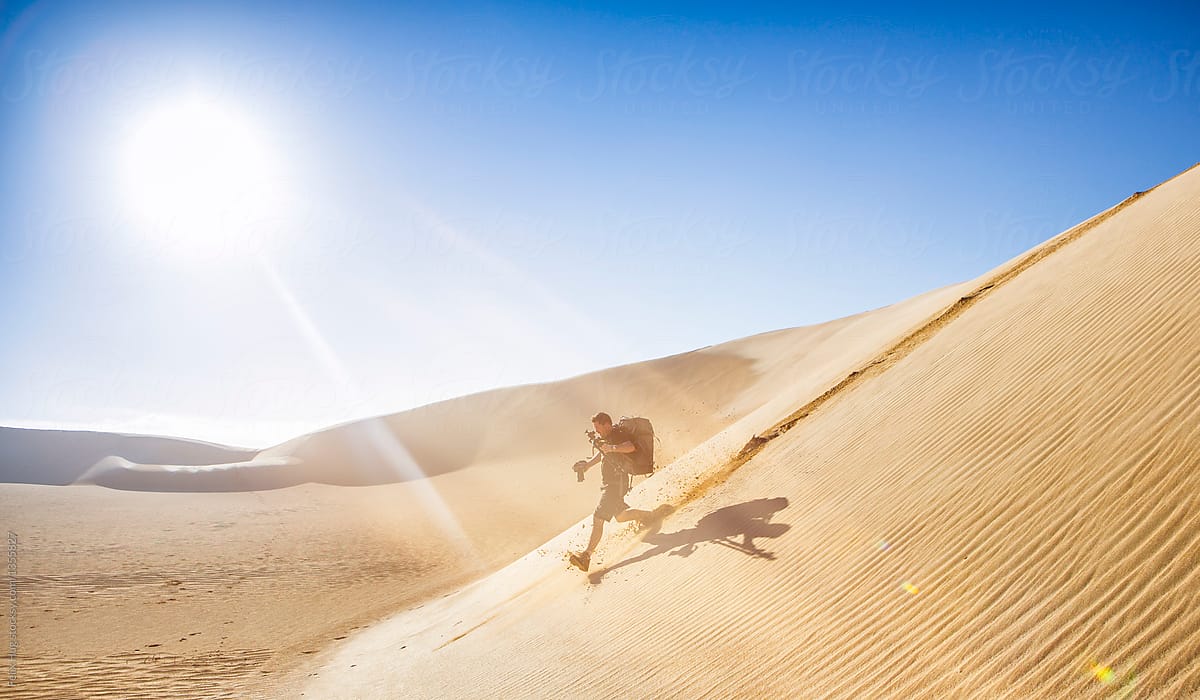 Phographer running down a dunes