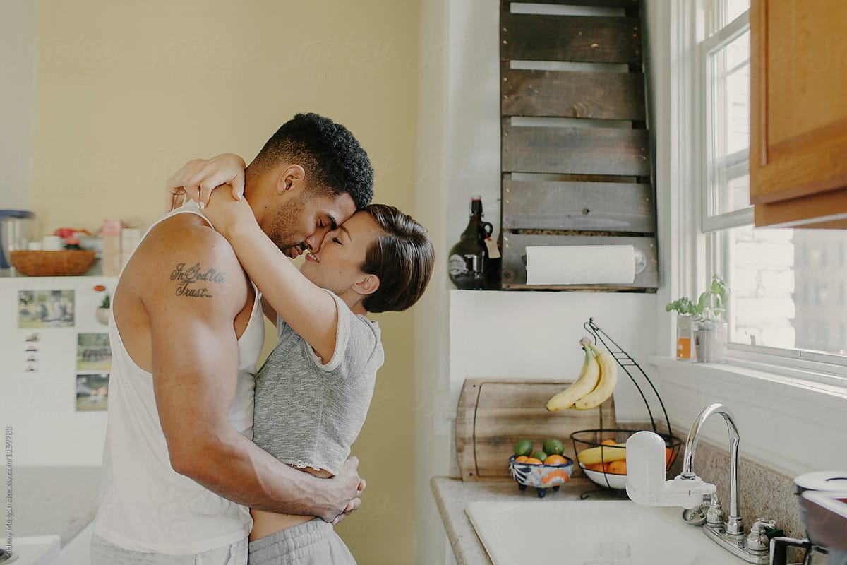 Mixed Race Couple Hugging In A Kitchen By Stocksy Contributor Sidney Scheinberg Stocksy 