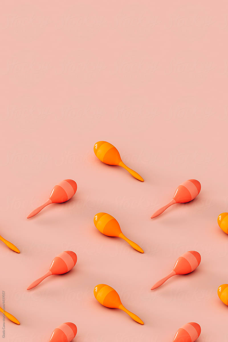 collection of colorful maracas on a pink background