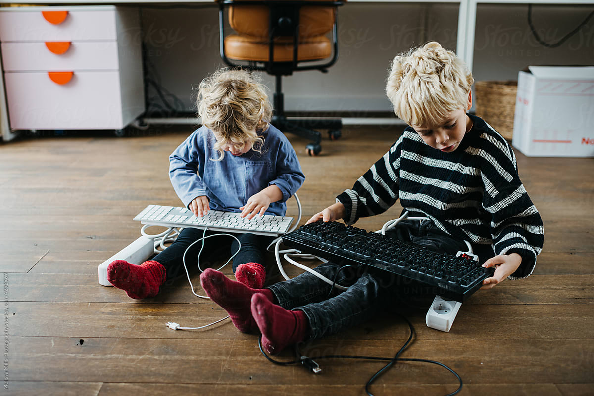 Children having fun with electronic devices at home