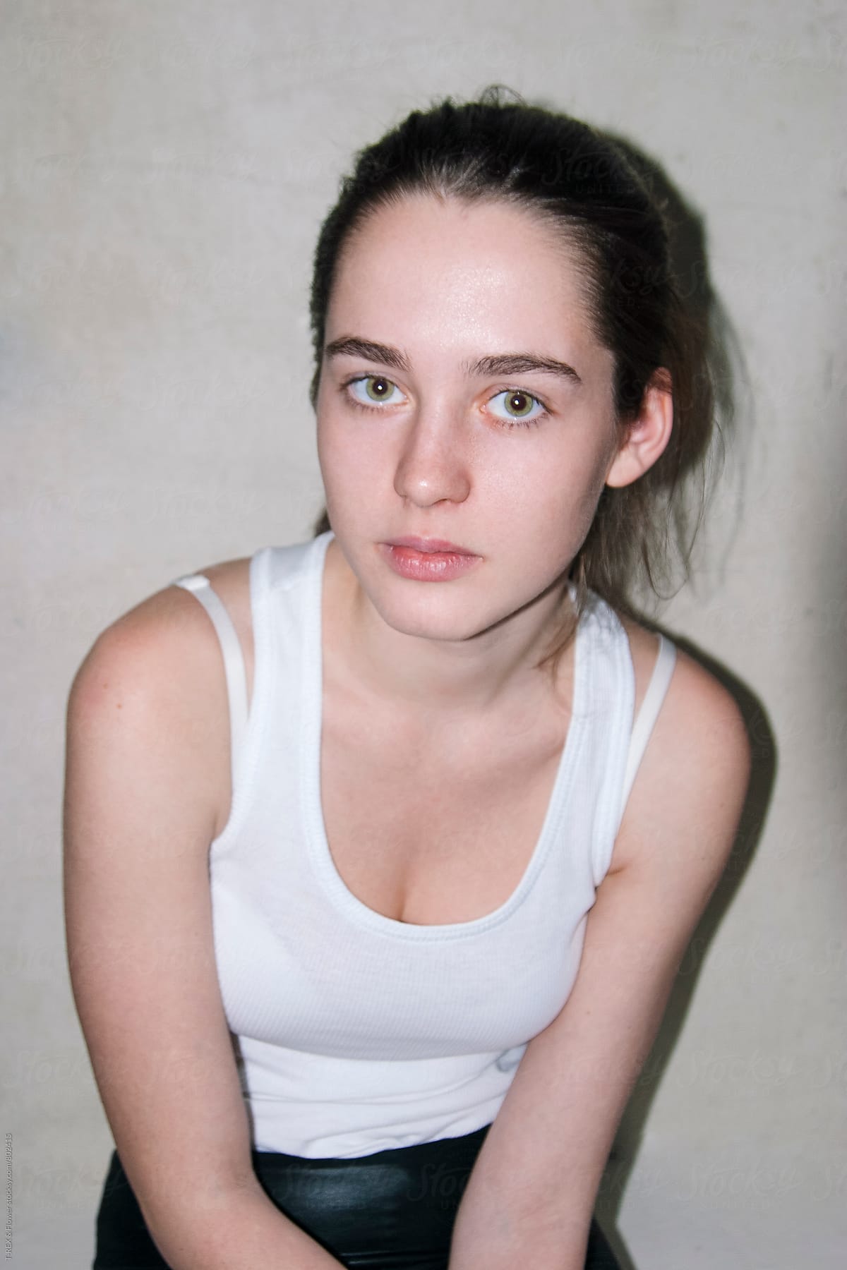 Portrait Of Young Brunette Woman With Bun By Stocksy Contributor Danil Nevsky Stocksy 