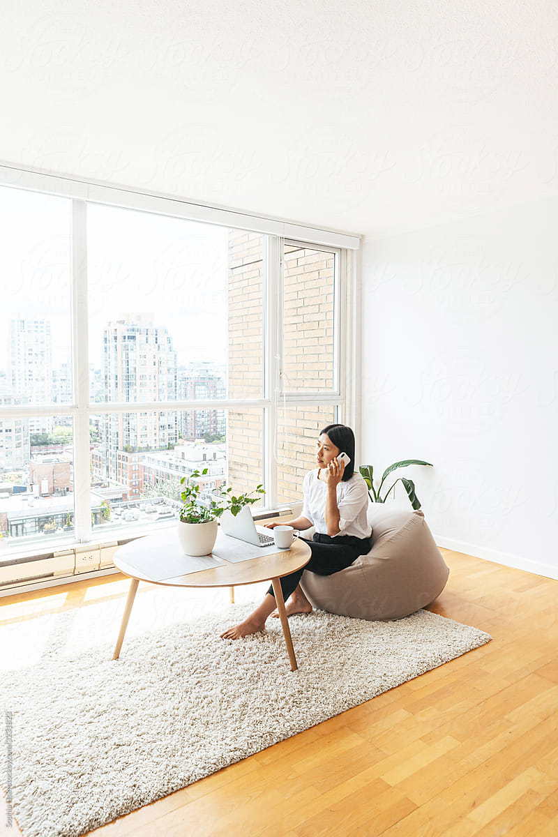 Female using cell phone in minimalist apartment