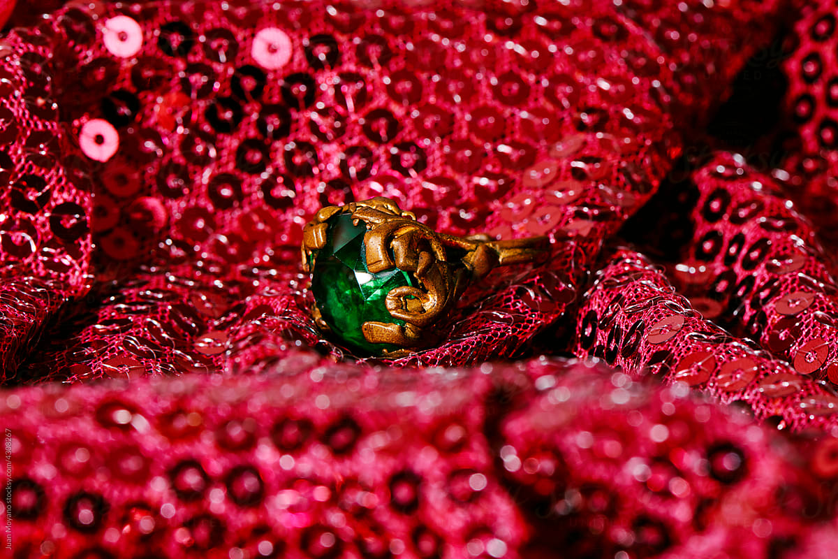 golden ring with a fake green gemstone