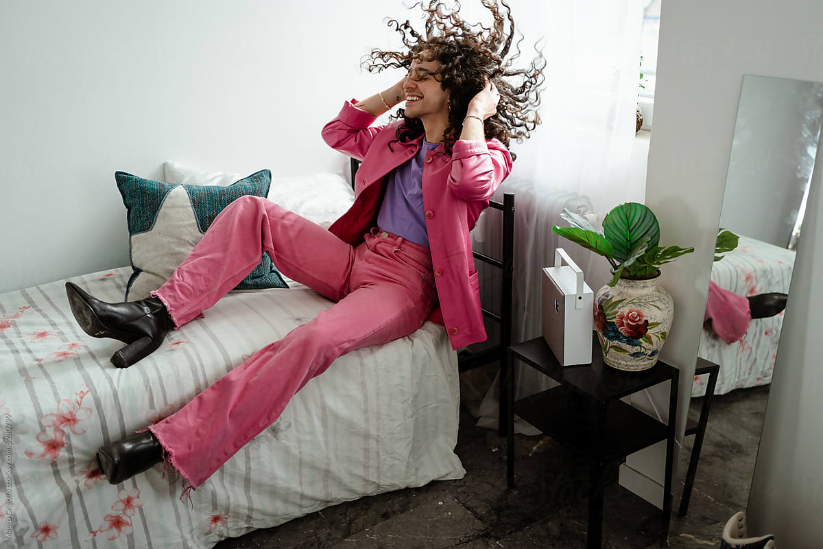 A man wearing pink clothes and having fun