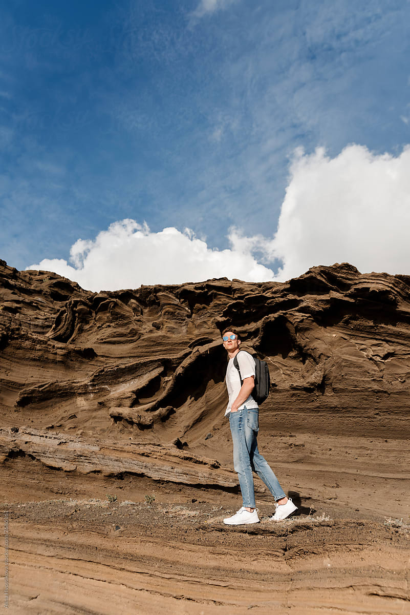 Traveler male standing on beautiful volcanic rock.