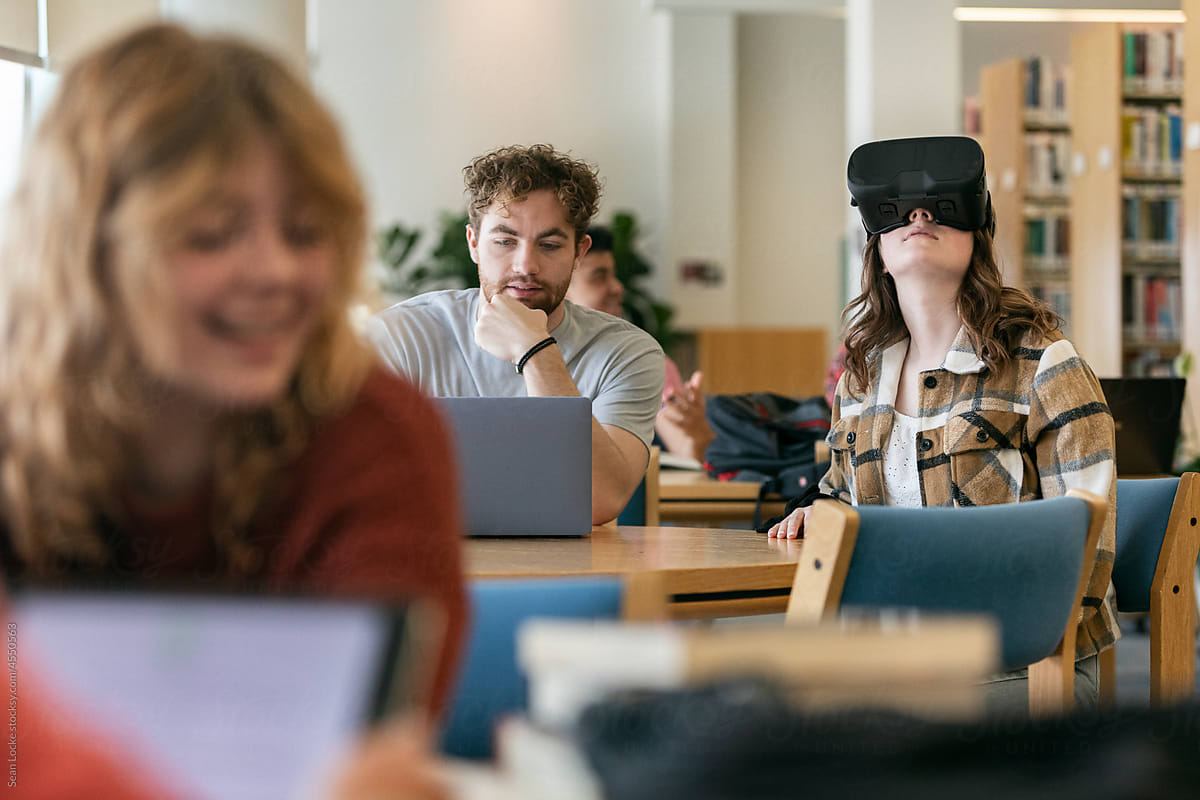 Classmates Use Laptop And VR Headset
