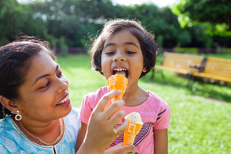 Mother and daughter enjoying an ice cream on a hot day
