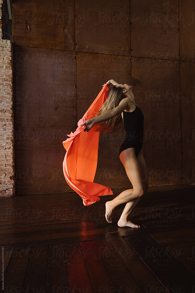 Woman dancing with an elastic salmon fabric