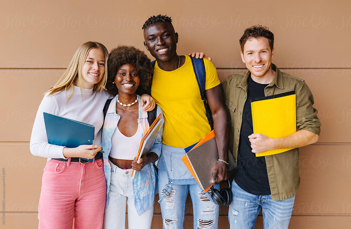 Cheerful multiethnic students standing in university hall