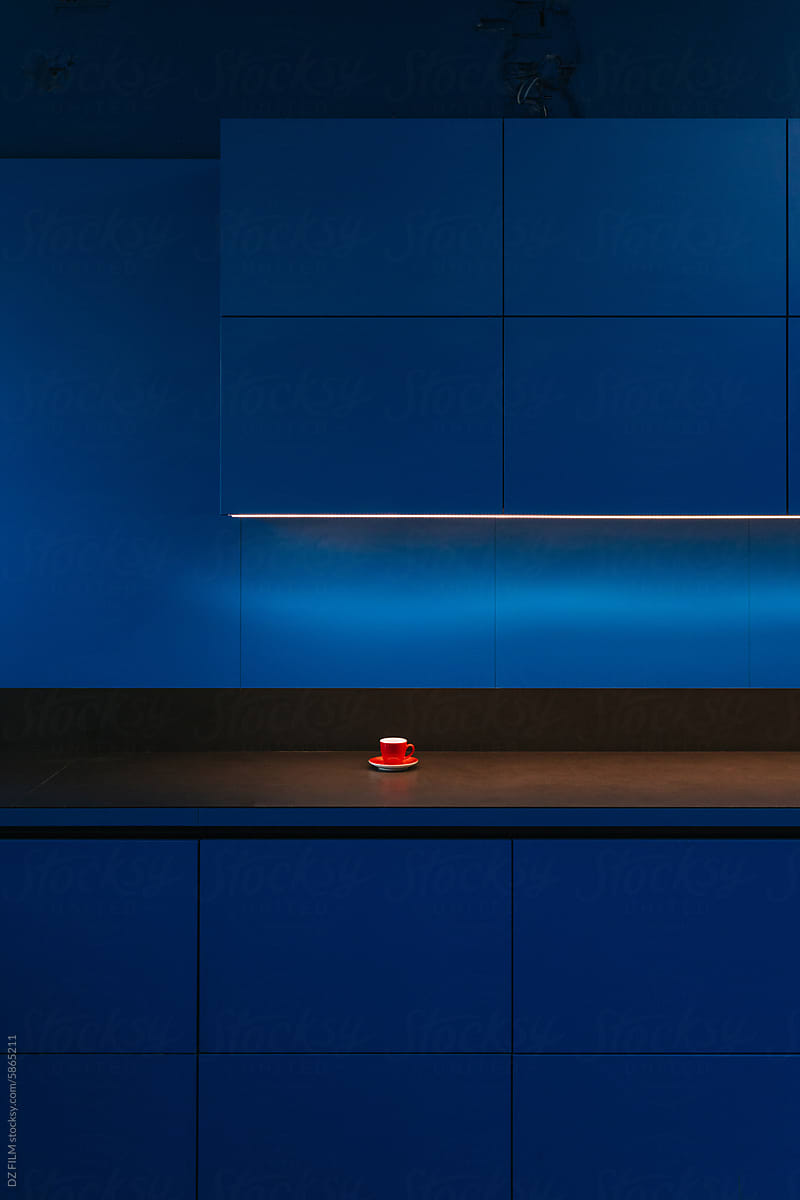 A red cup in a blue kitchen