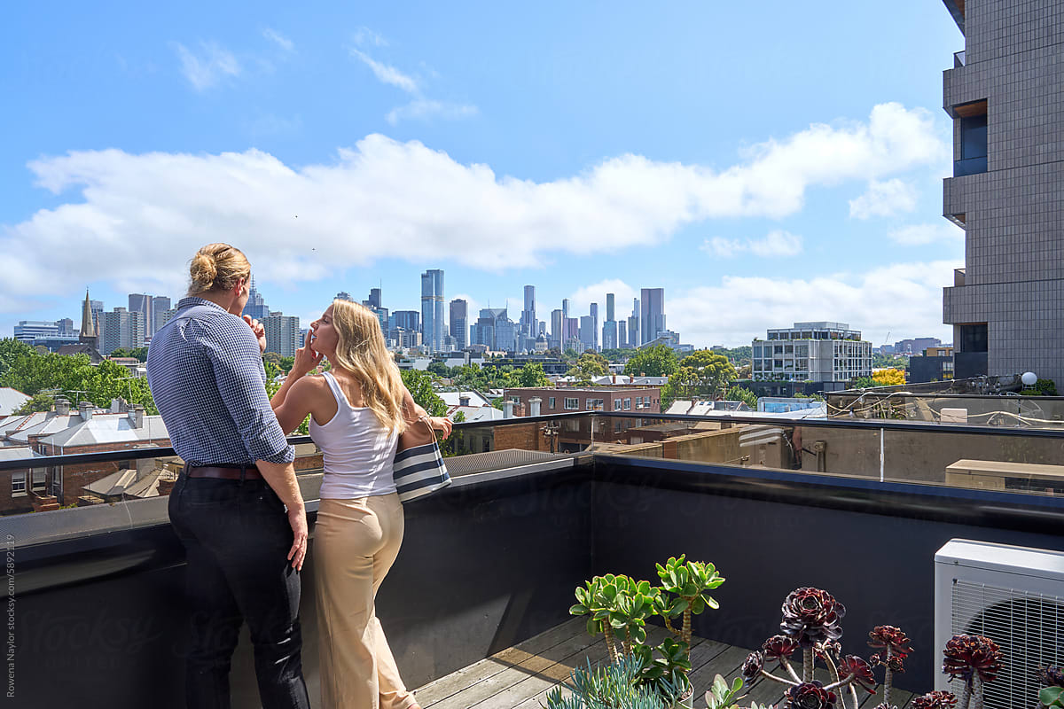 Couple at Real Estate inspection on balcony of apartment