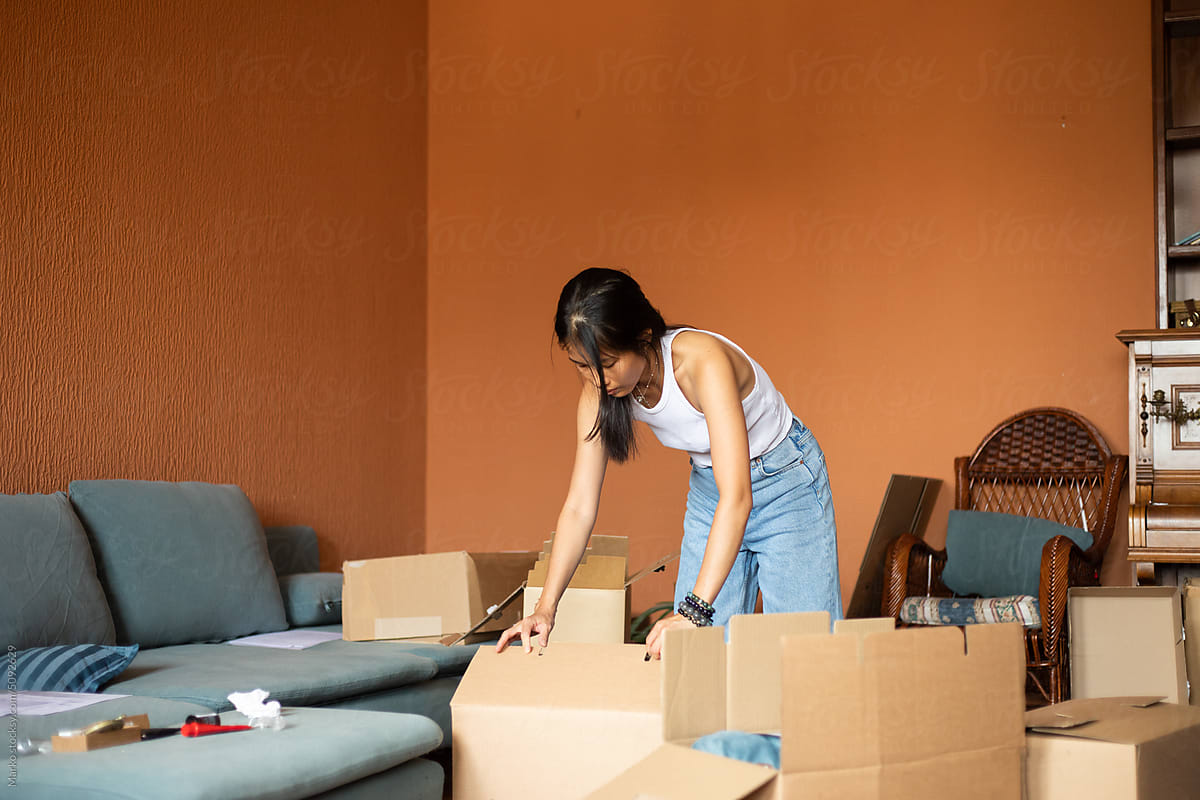 Woman packing boxes for moving