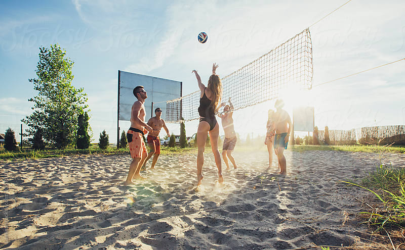 Group of Young People Playing Beach Volleyball