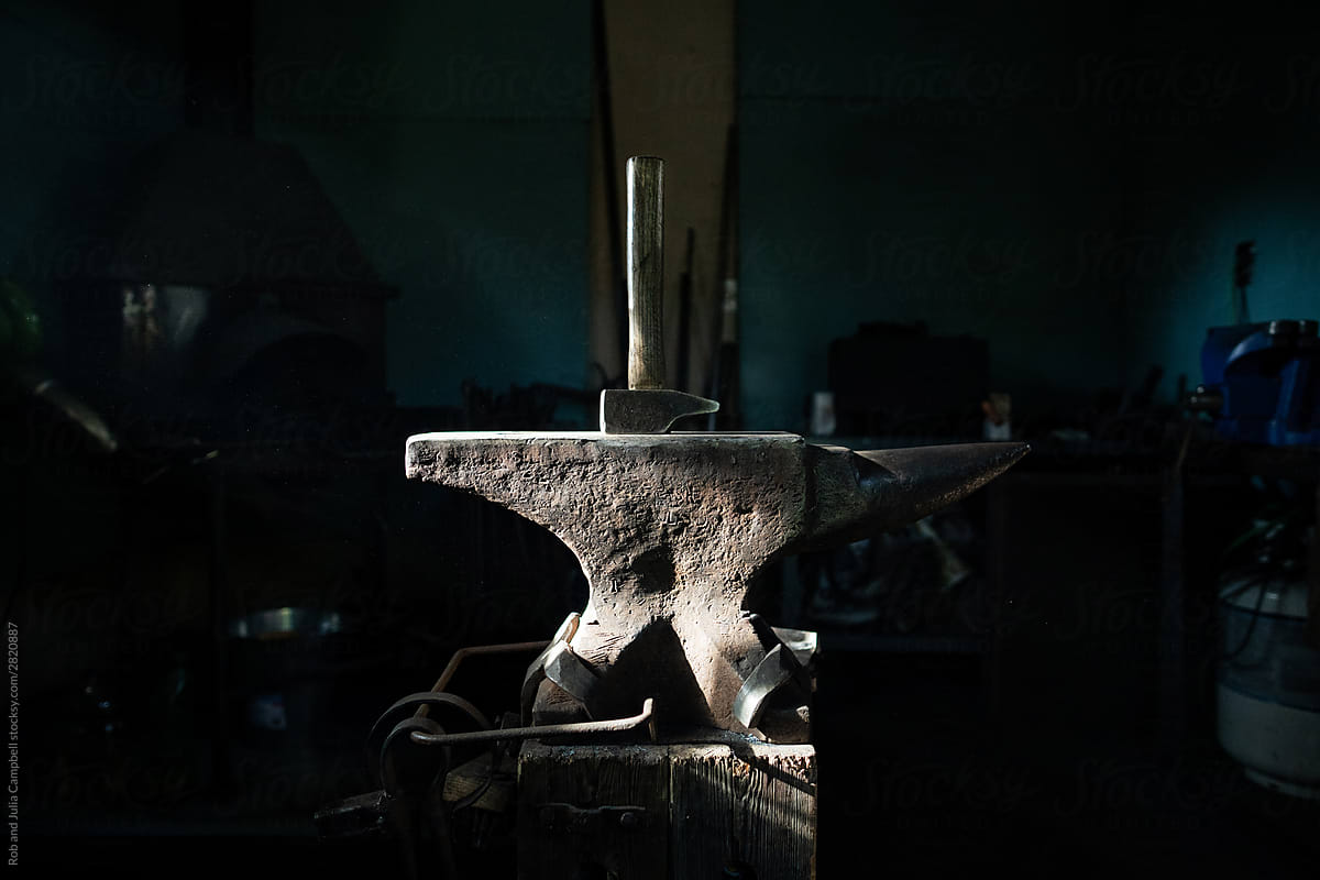 Anvil and hammer in blacksmith workshop.
